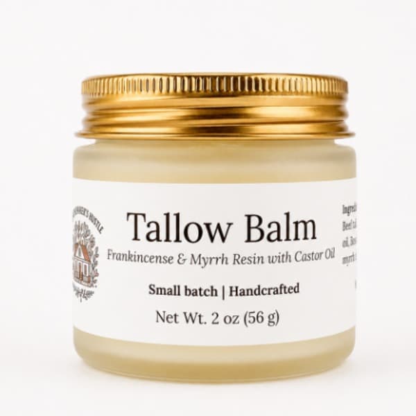 A frosted jar with a gold lid and white label, containing Frankincense and Myrrh resin tallow balm